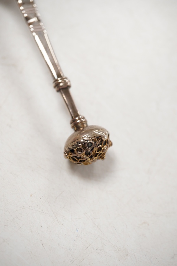 A late 18th/early 19th century Swedish? white metal spoon, with pierced parcel gilt finial, indistinct marks on the stem, 15cm.